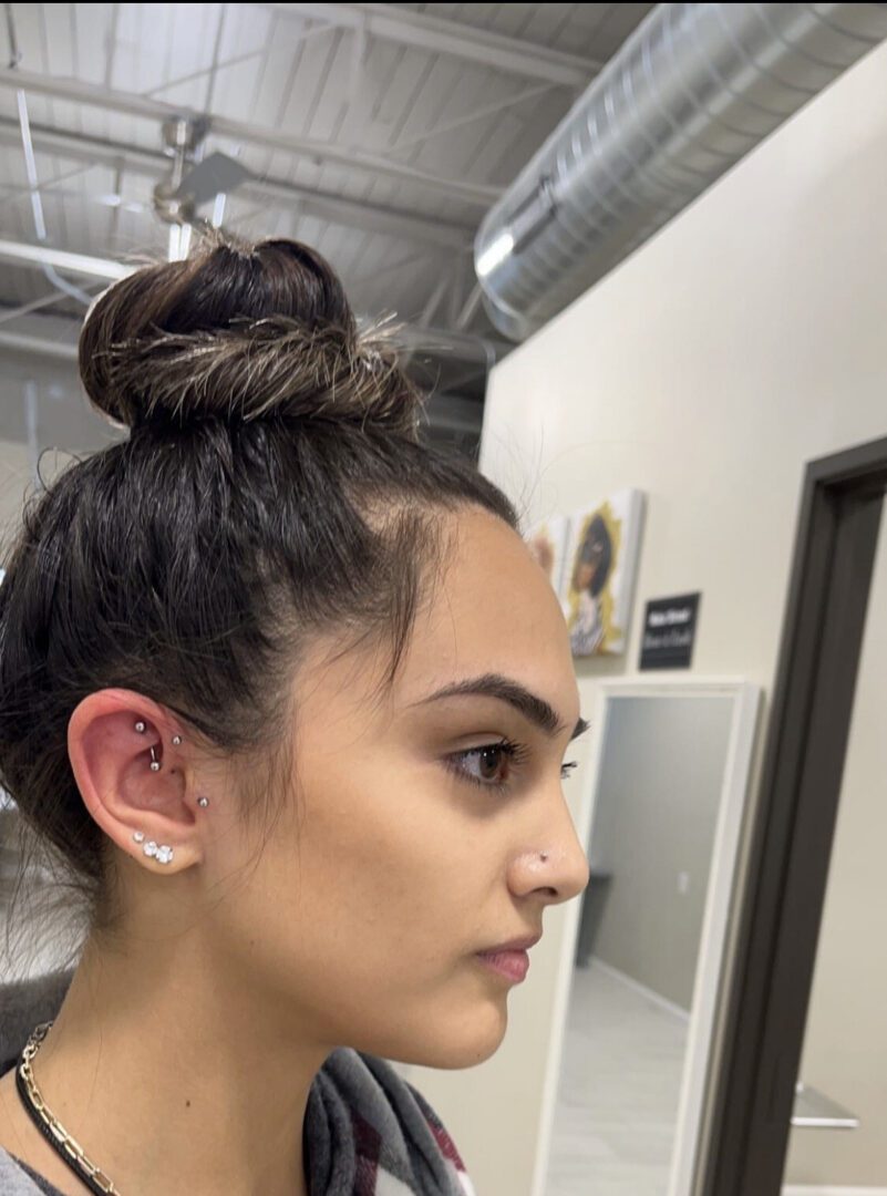 A woman with her ear piercings in an office.