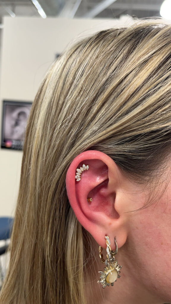 A woman with long hair and ear piercings.